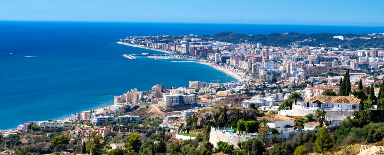 VALLEY COLLECTION area photograph showing an elevated panoramic view of Fuengirola's coastline, marina, beaches and urban skyline on the Costa del Sol, Spain.